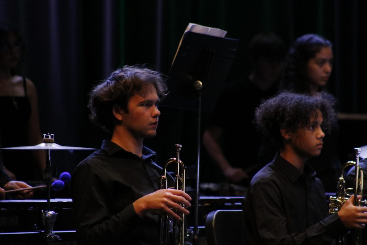 A Trumpet player waits patiently to play.