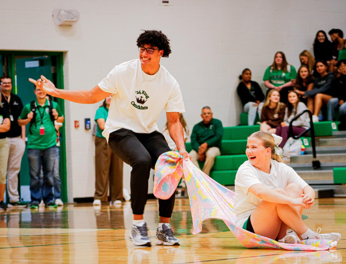 Senior Da'saahn Brame laughs and points while dragging senior Delaney Francis.