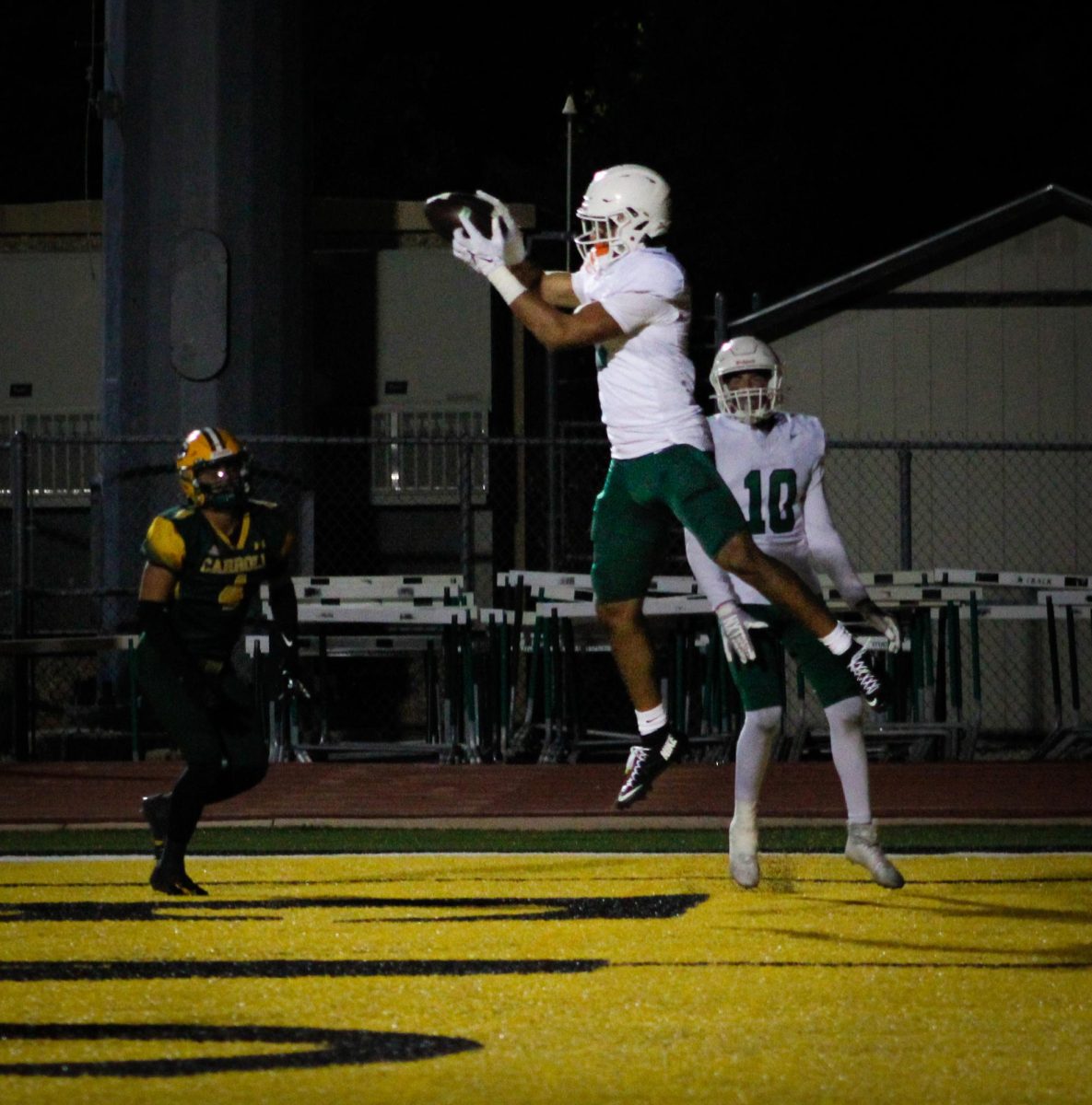 Player jumps in the air after scoring touchdown. 