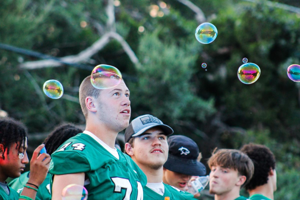 Football players look at bubbles 