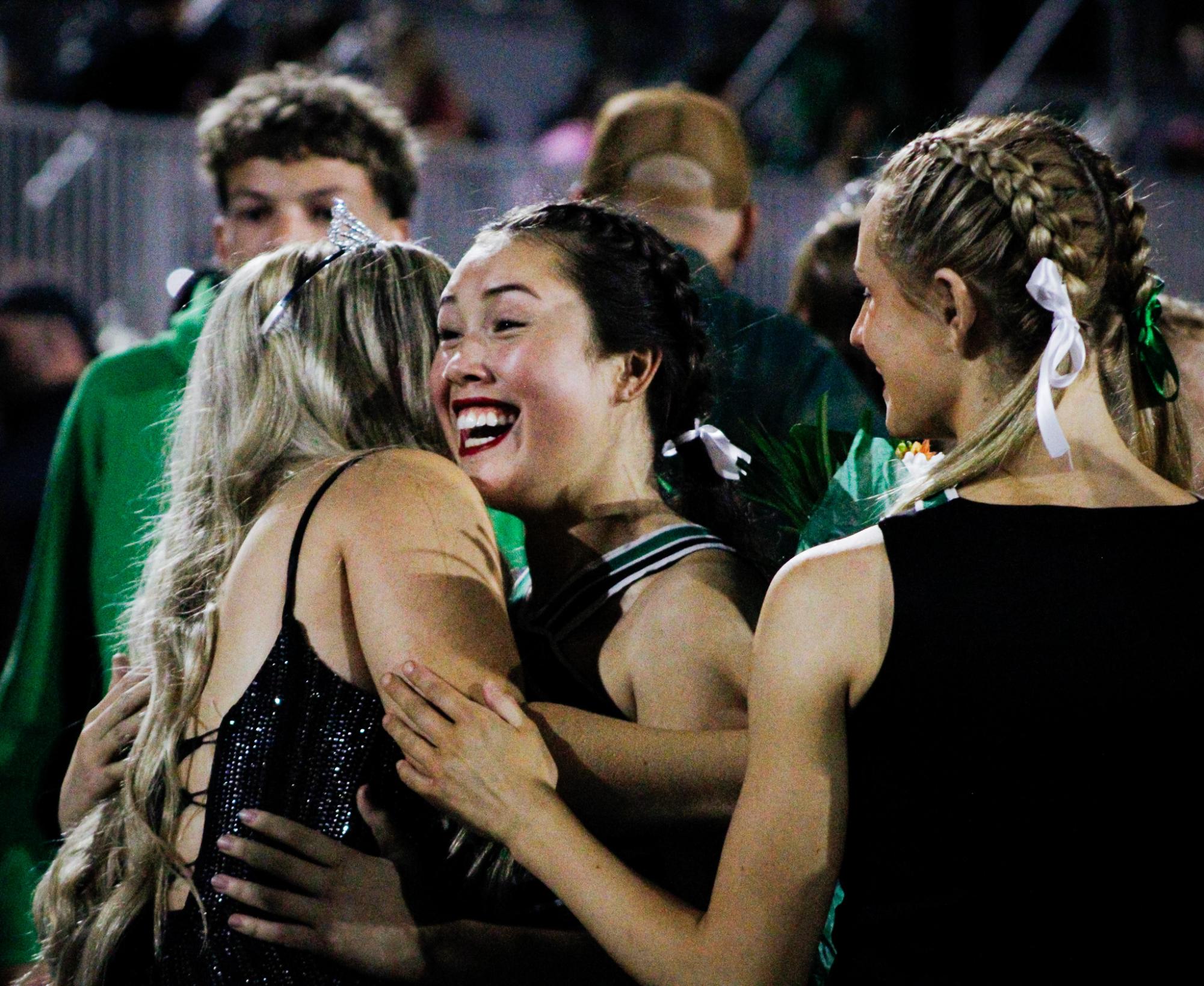 Senior Delaney Francis and junior Sherro Pennington share a hug.