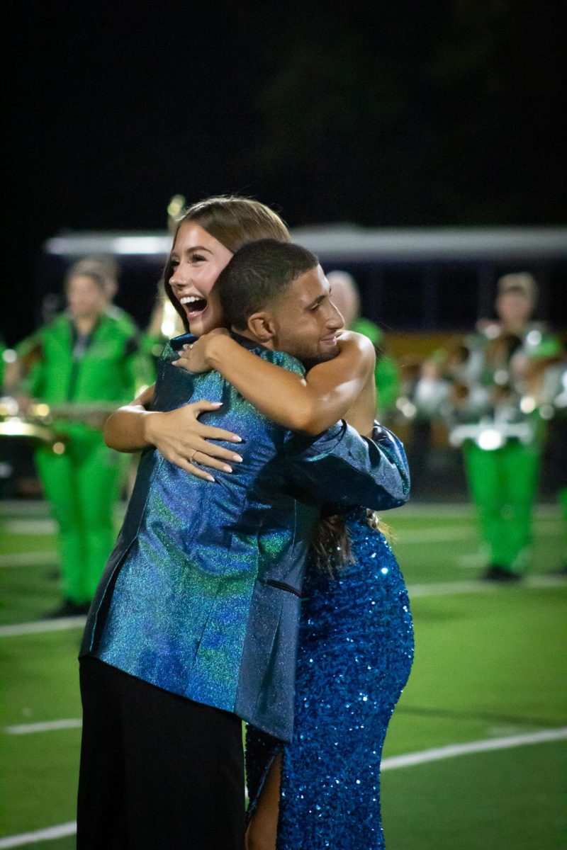 Seniors Mallory Baker and Boston Dunn hug after being named homecoming kind and queen. 