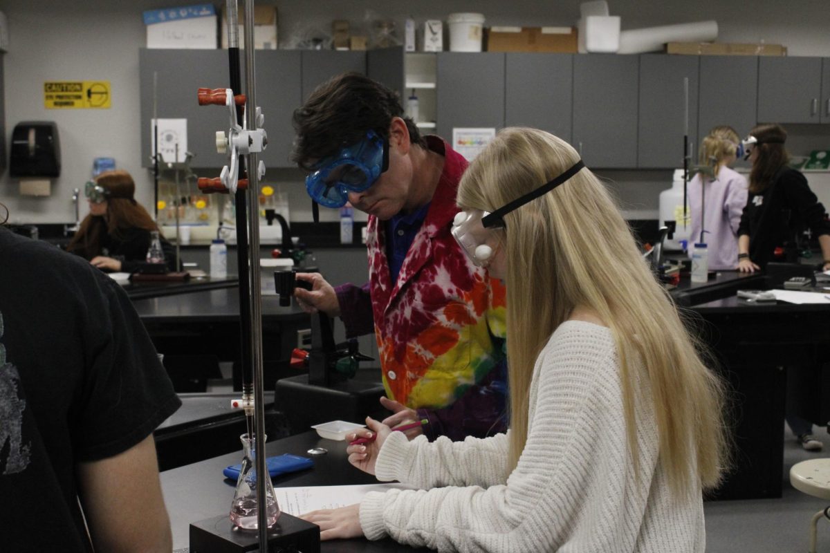 Mr. Holland helping student in lab.