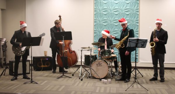 Jazz band performs carols during event.