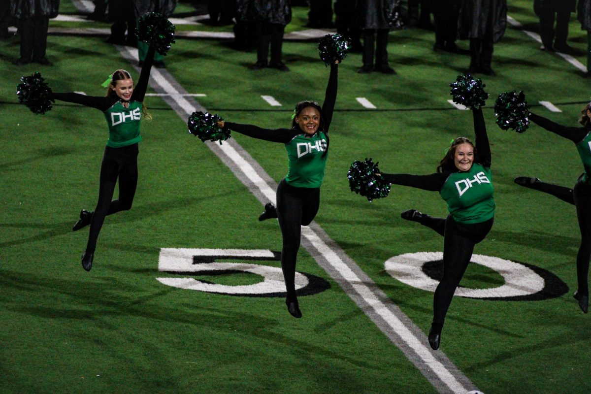 Pantherettes leap for routine during the half-time show. 