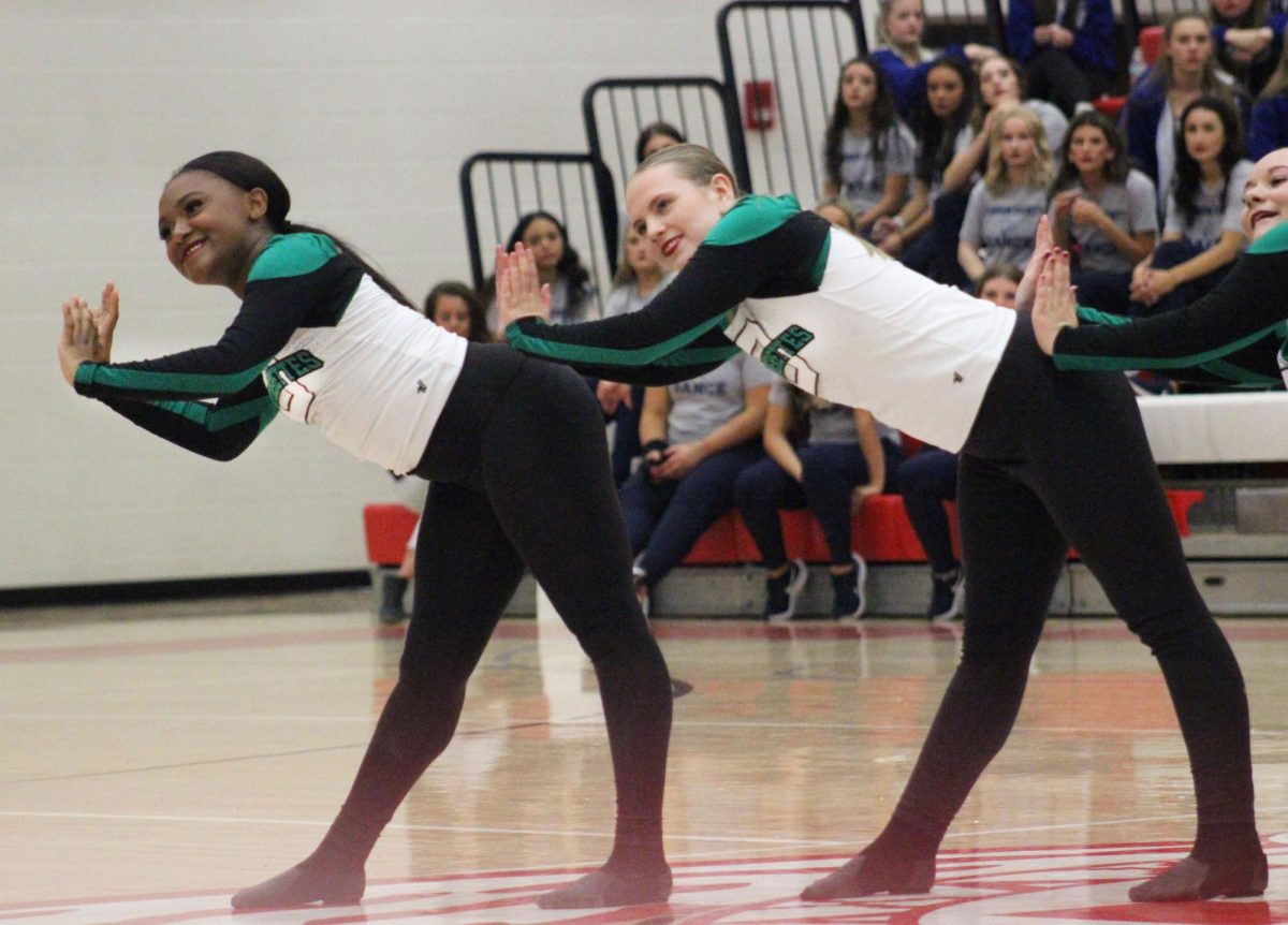 Sophomore Brooklyn Profit and Freshman Breanna Walker dance to the Pantherette routine at Wichita North.