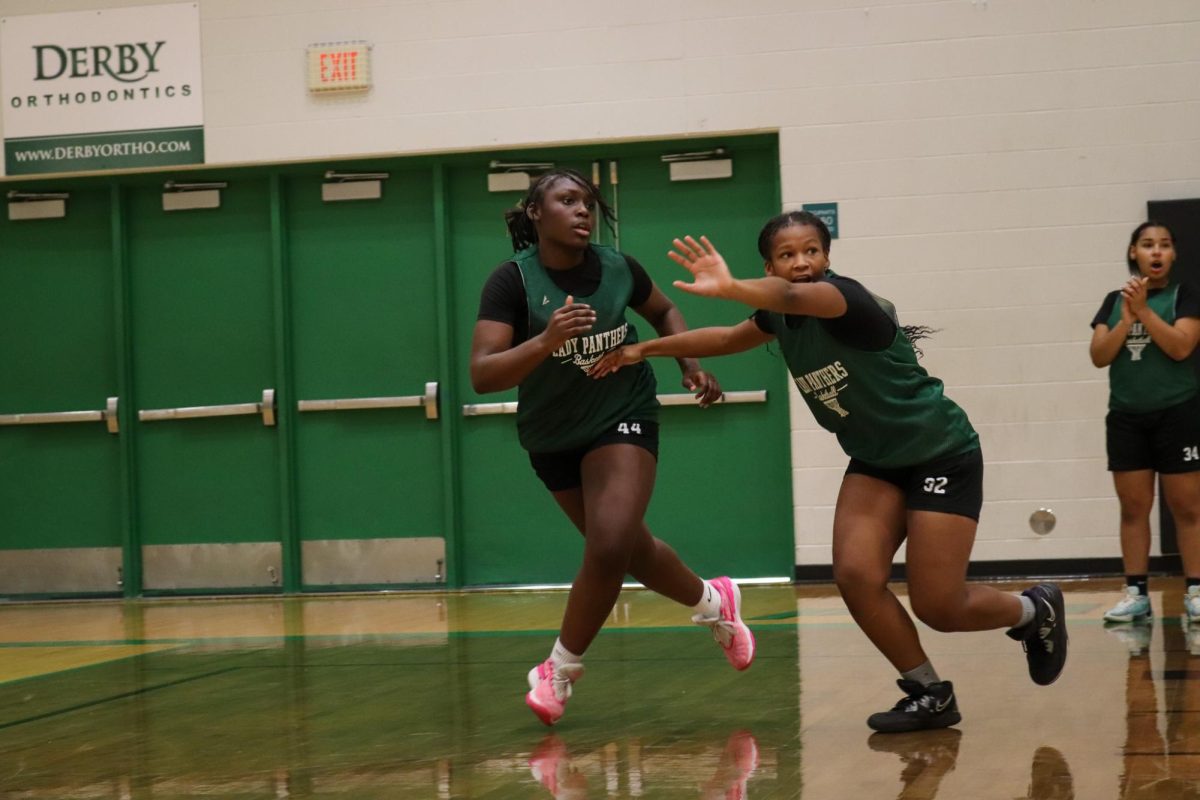 Students run and block during drill.