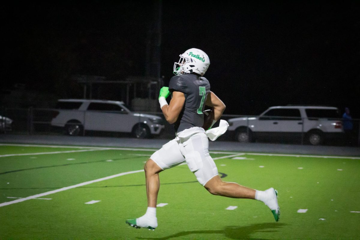 Player runs across field to make touchdown. 