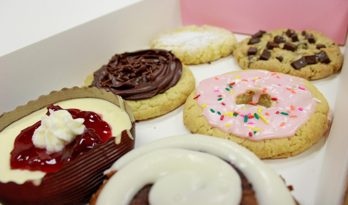 Yearbook staff shares Crumbl cookies together on Nov. 13 work night. “The cookies were really good and it was funny to film the tiktok because we were filmed really close,” sophomore Sophie Segelke said. Staff also created a “Mukbang” with these cookies for the derby publications TikTok page.