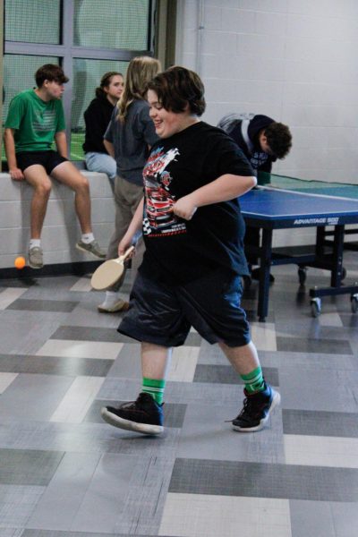 Student jogs to stop the ball from bouncing. 