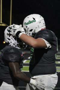 Two players celebrate a touchdown.