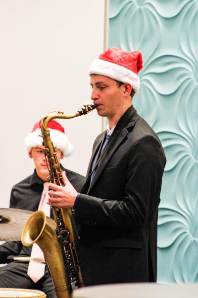 Jazz Band member plays the saxophone. 