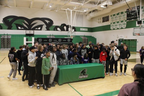 Football team joins their friends for a photo.