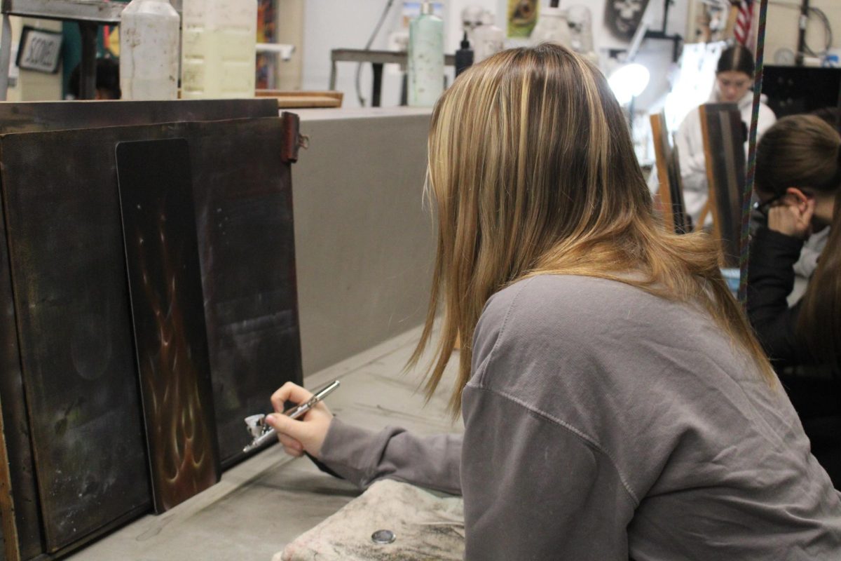 Student using airbrush to make artwork