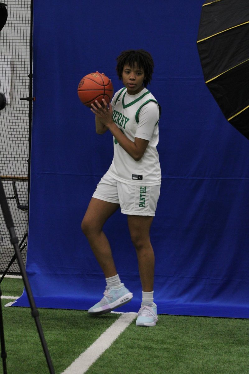 Basketball player getting their picture taken.