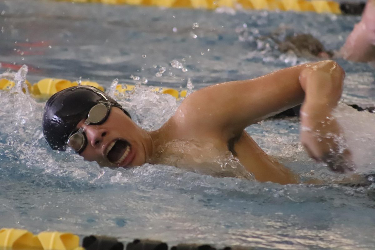 Junior Derek Tamayo Trejo reaches as he breathes.