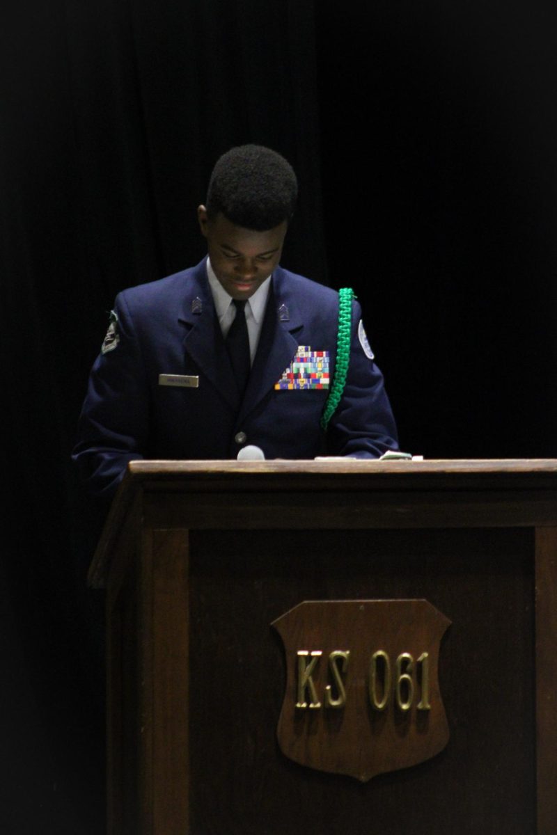 AFJROTC member reads speech while up at the podium. 