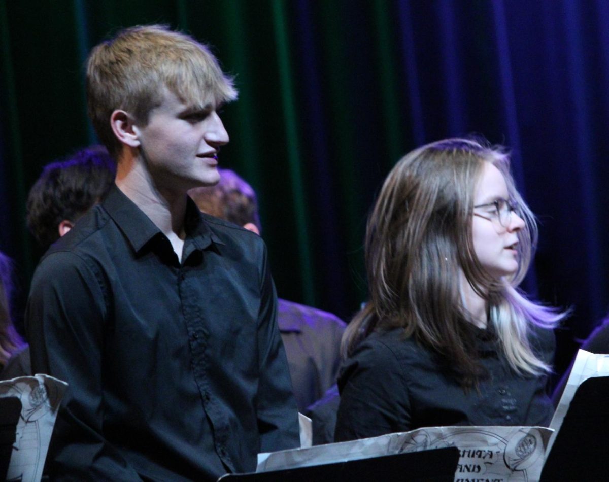 Sophomore James Lyman and another student face their attention to the conductor.