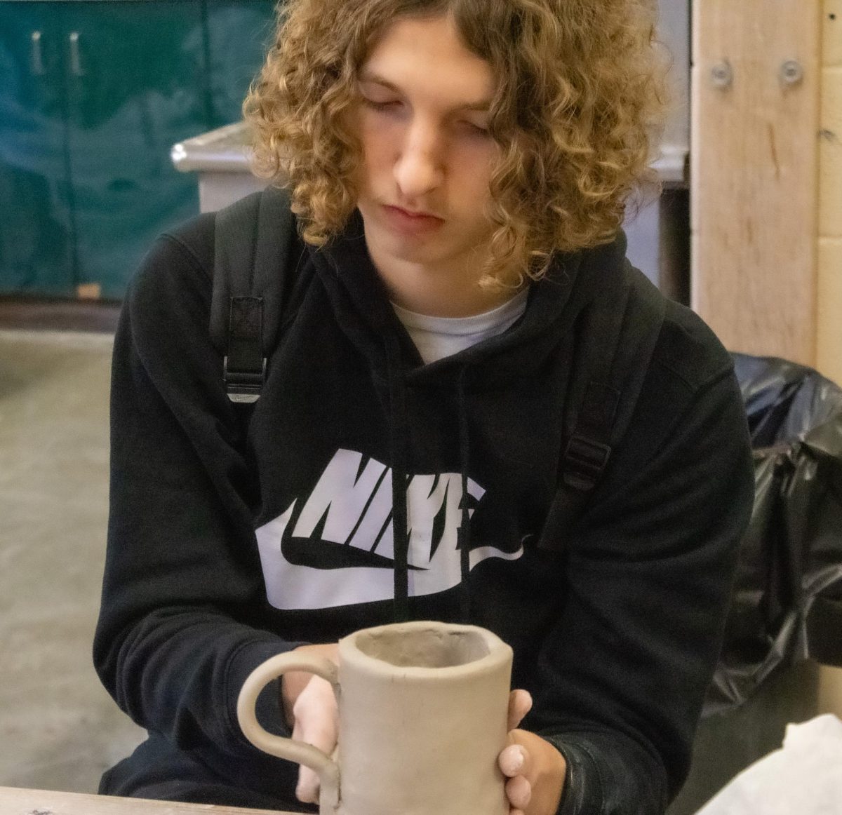 Student works on mug in clay.