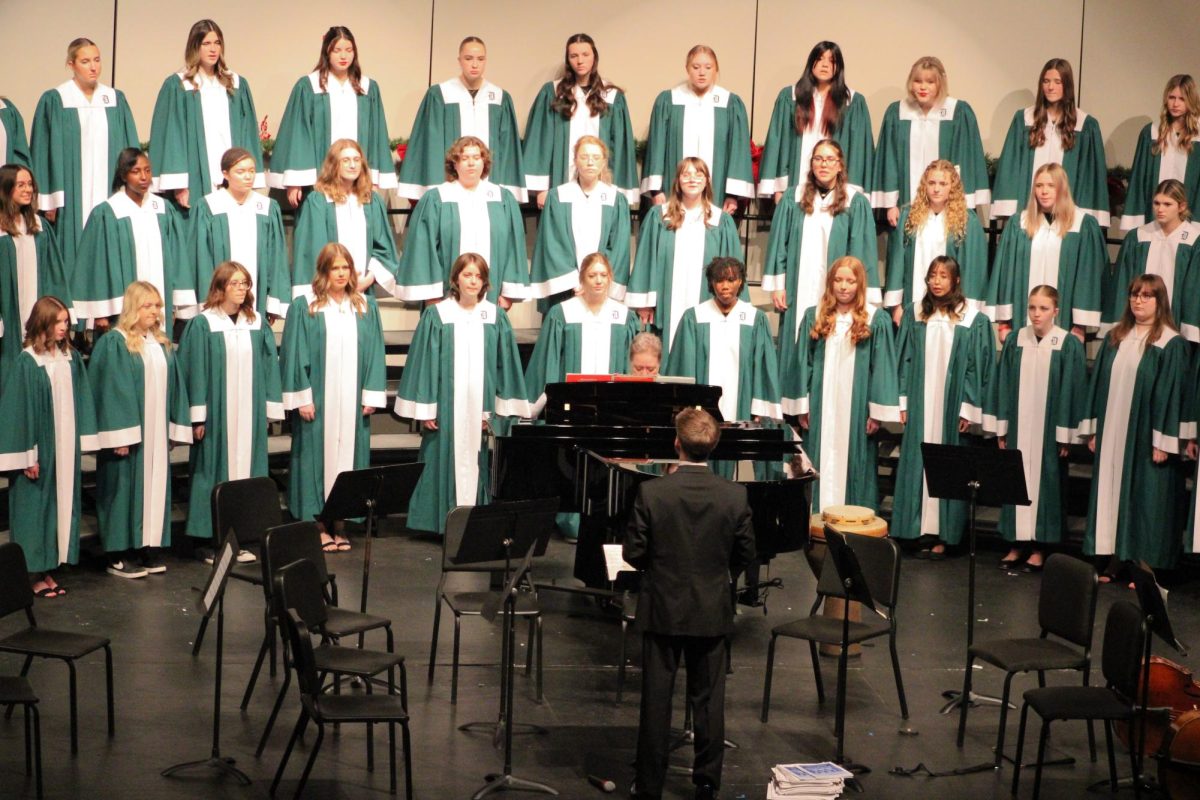 Student teacher Dylan Boldt conducts the women's choir.