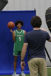 Basketball player poses for photo with basketball.