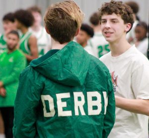 Junior Jackson Flanders talks to a teammate before photos.