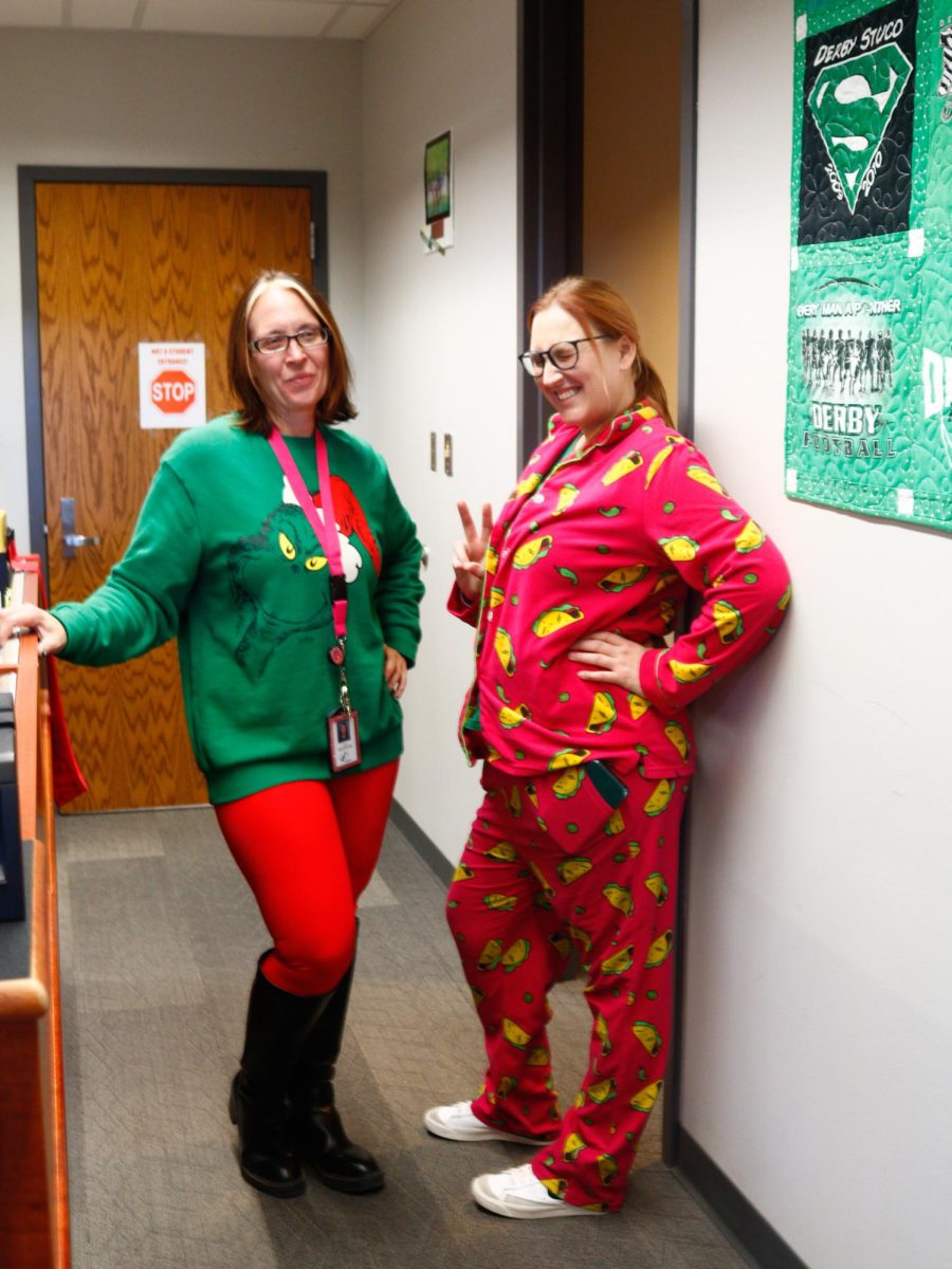 Attendance secretary Candace Morgan and Derby High School counselor Amy Andrews pose in their pajamas for pajama day.