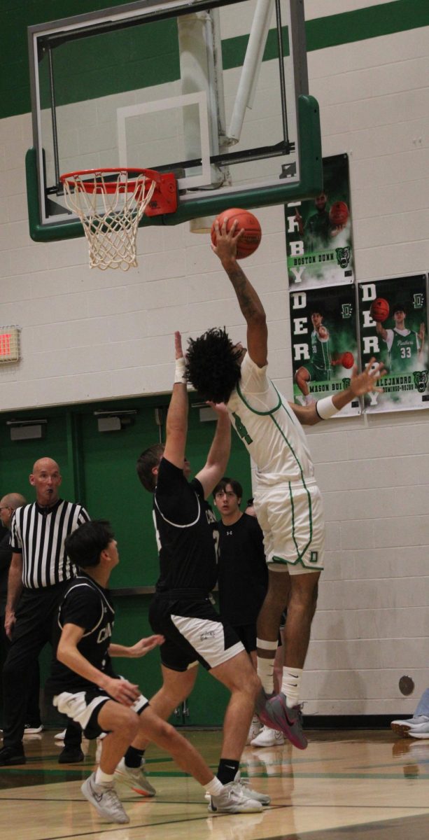 Player jumps in air to make basket.