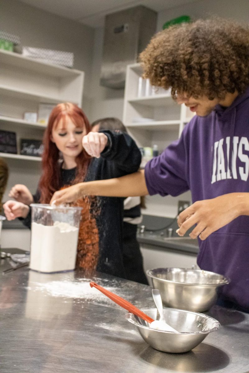 Student adding base into batter.