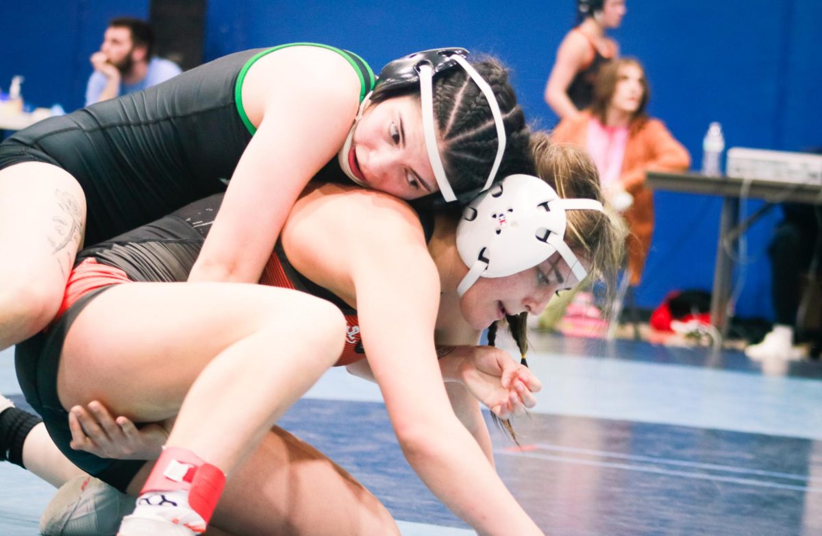 Senior Myrta Sanchez wrestles her opponent.