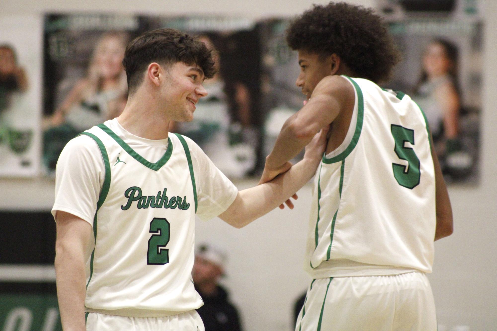 Seniors Jack Ulwelling and Cayden Titus celebrate after a basket.