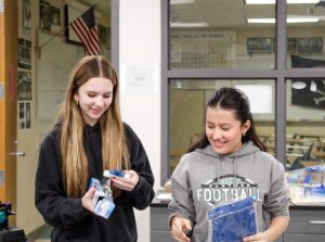 Sophomores Abby Welk and Sarah Rawlz Lopez find supplies to contribute to the banner.