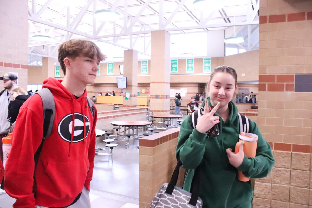 Students posing while walking in the hallway