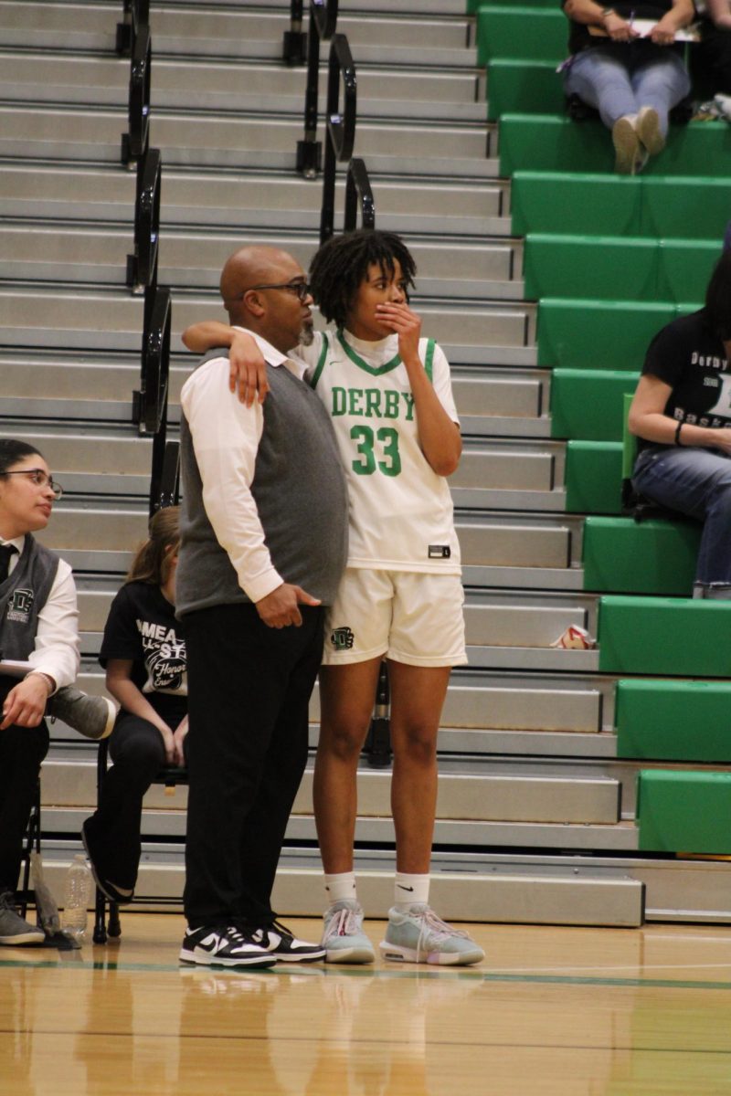 Player and coach watch the game together