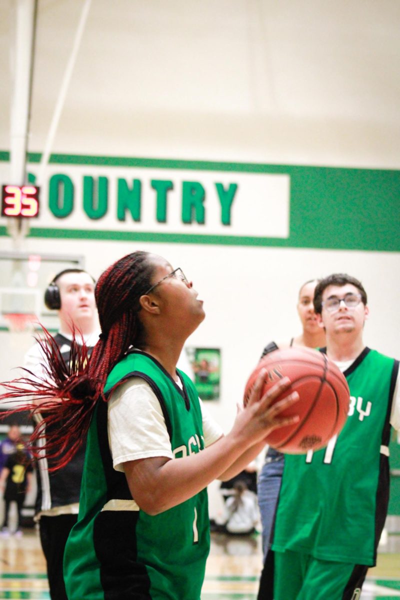 Player looks up at the goal while preparing to shoot the ball. 