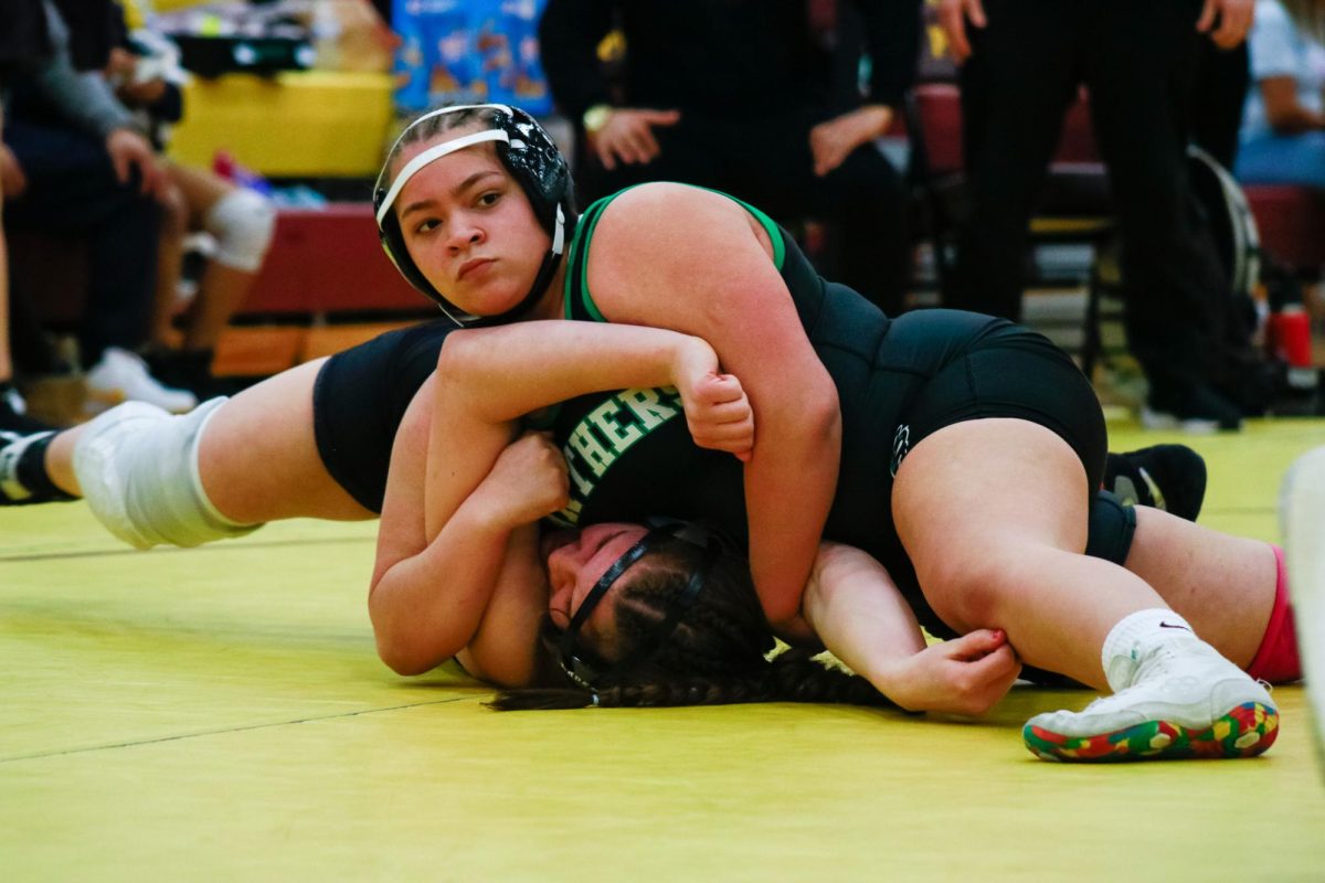 Junior Chloe Spears tries to pin her opponent.