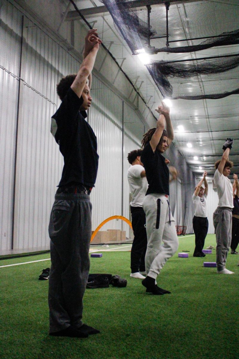 Players stretch their arms and back. 