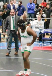 Senior Milan Colvin Takes his shoes off after winning state 