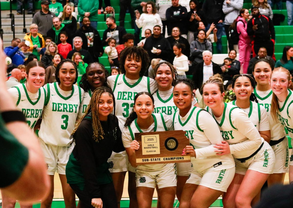 After their sub-state final win, the panthers pose for a photo with the plaque.