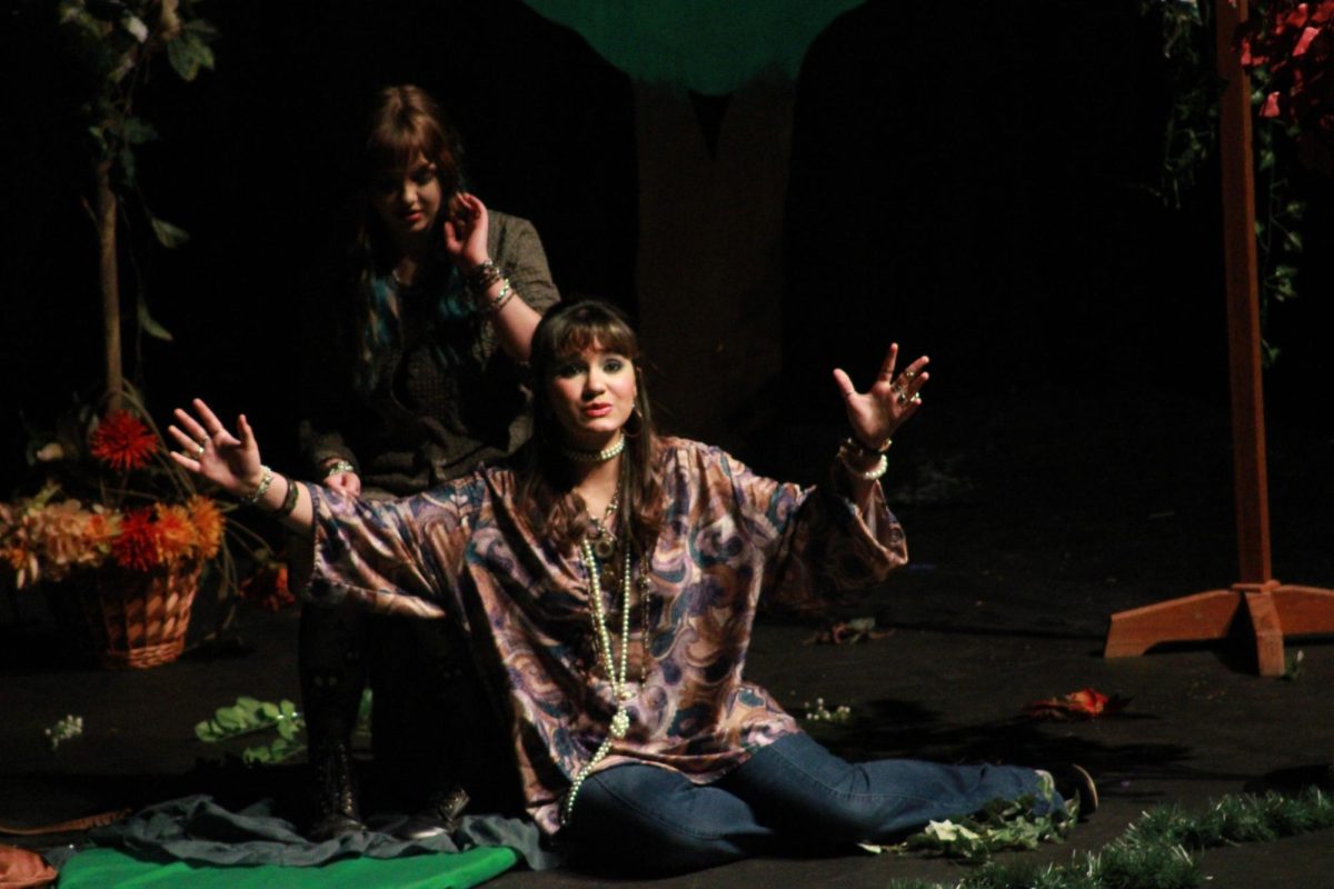 Freshmen Jaycee Pappan and Lily Dannis perform on stage.