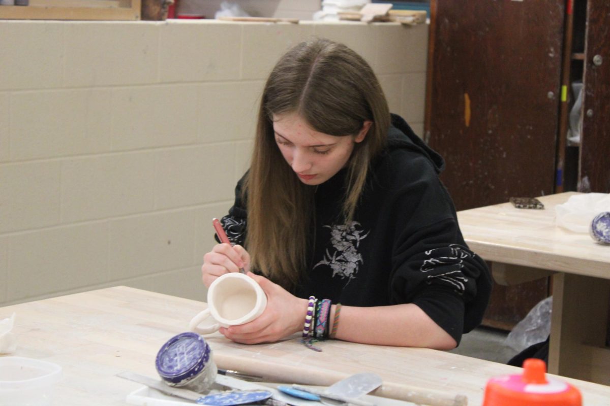 Students work on their clay pots in class.