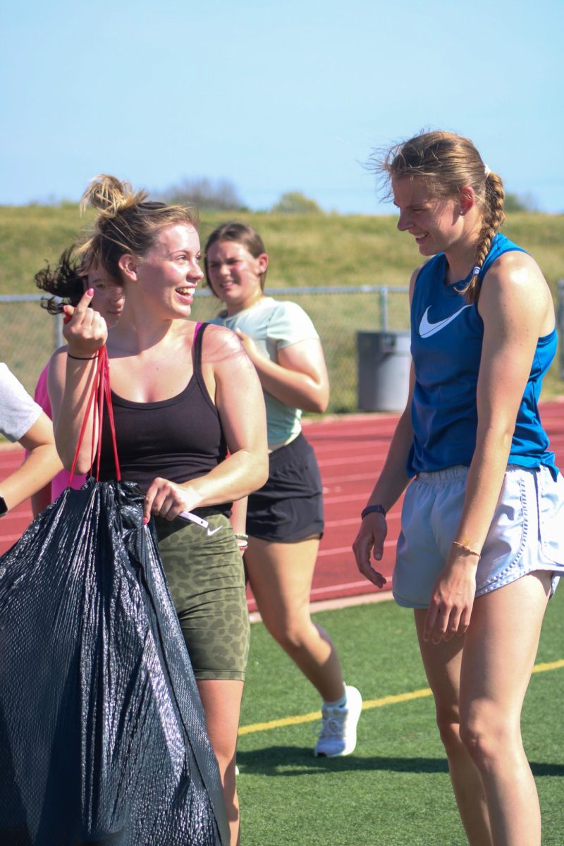 students getting trash for team building