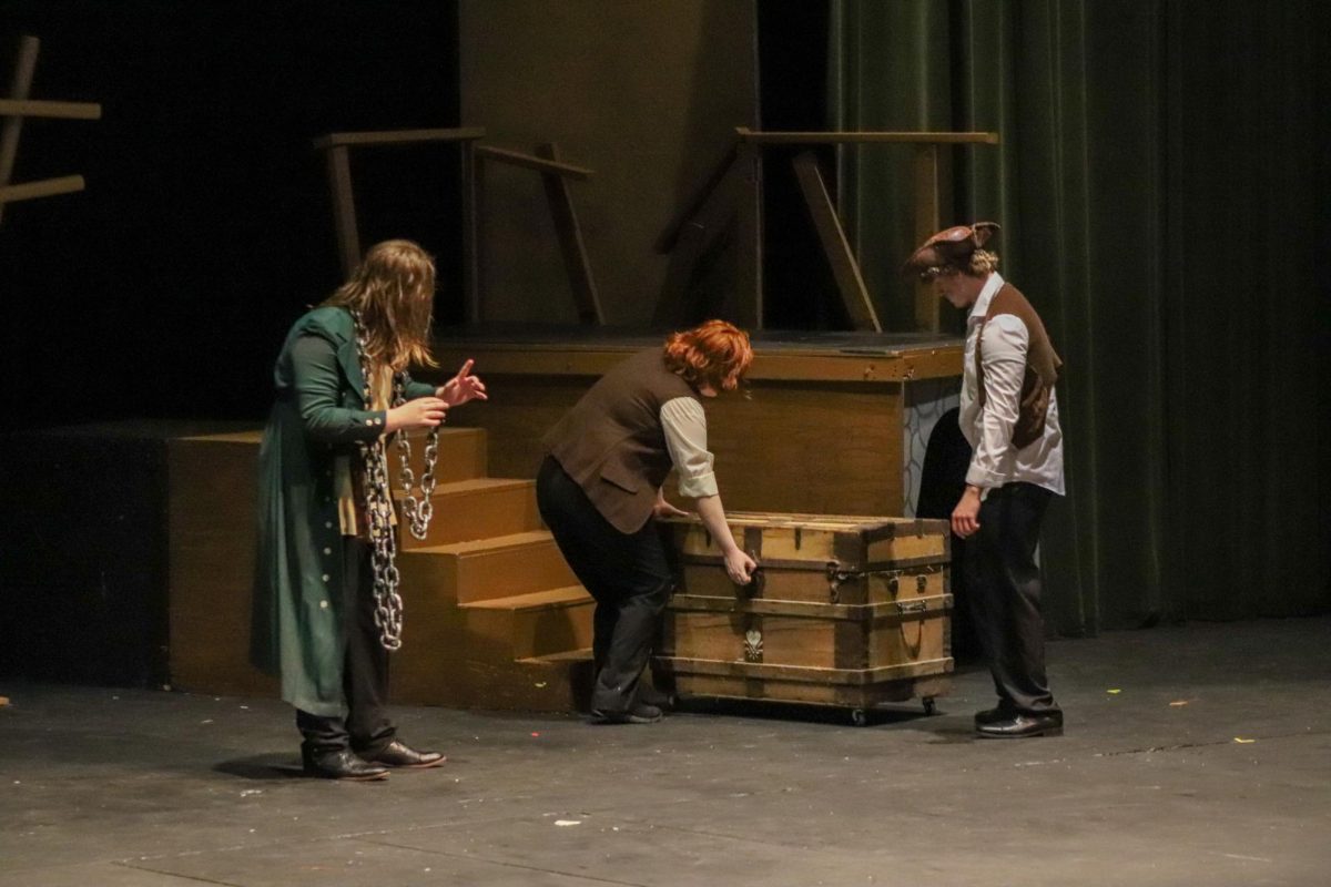 Students perform a song on stage 