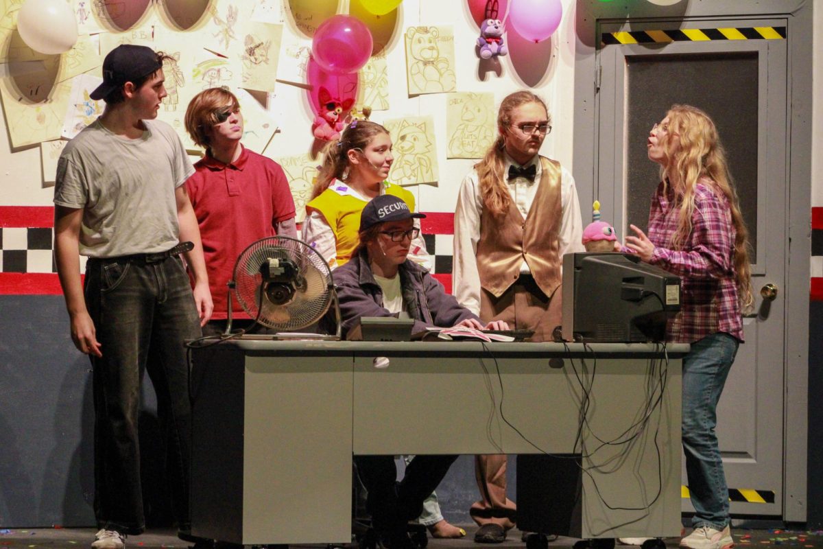 Students perform on stage.