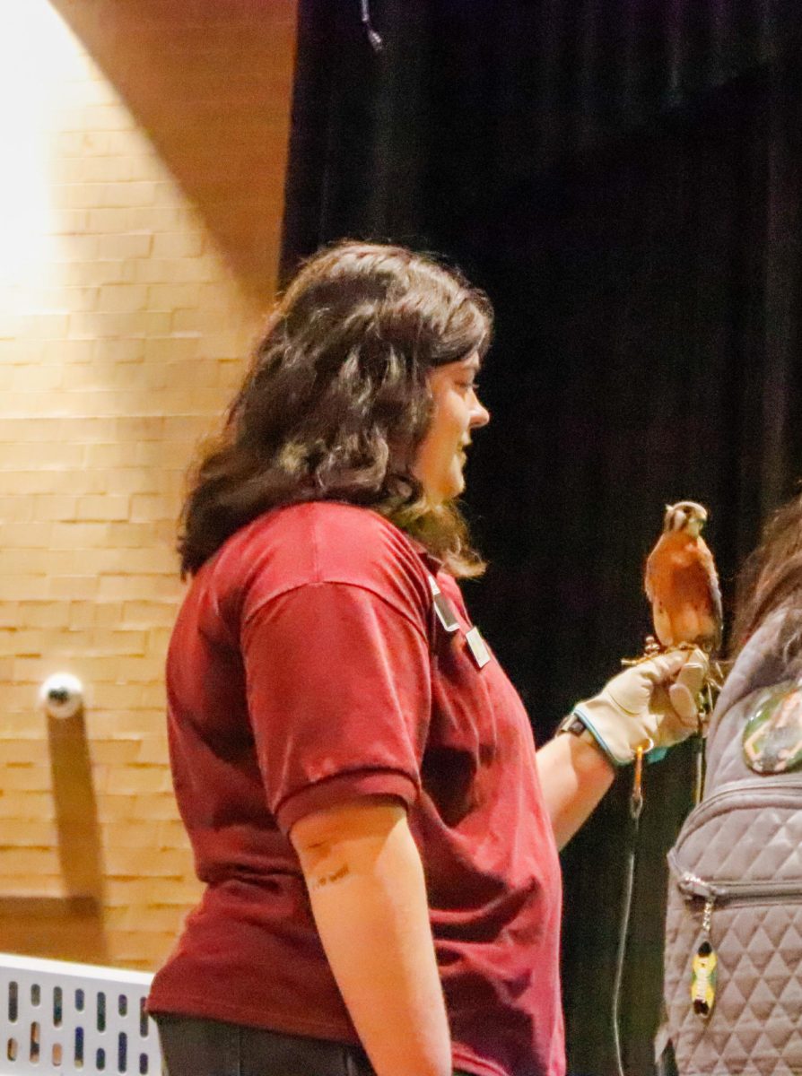 Worker from Great Plains Nature Center with the bird