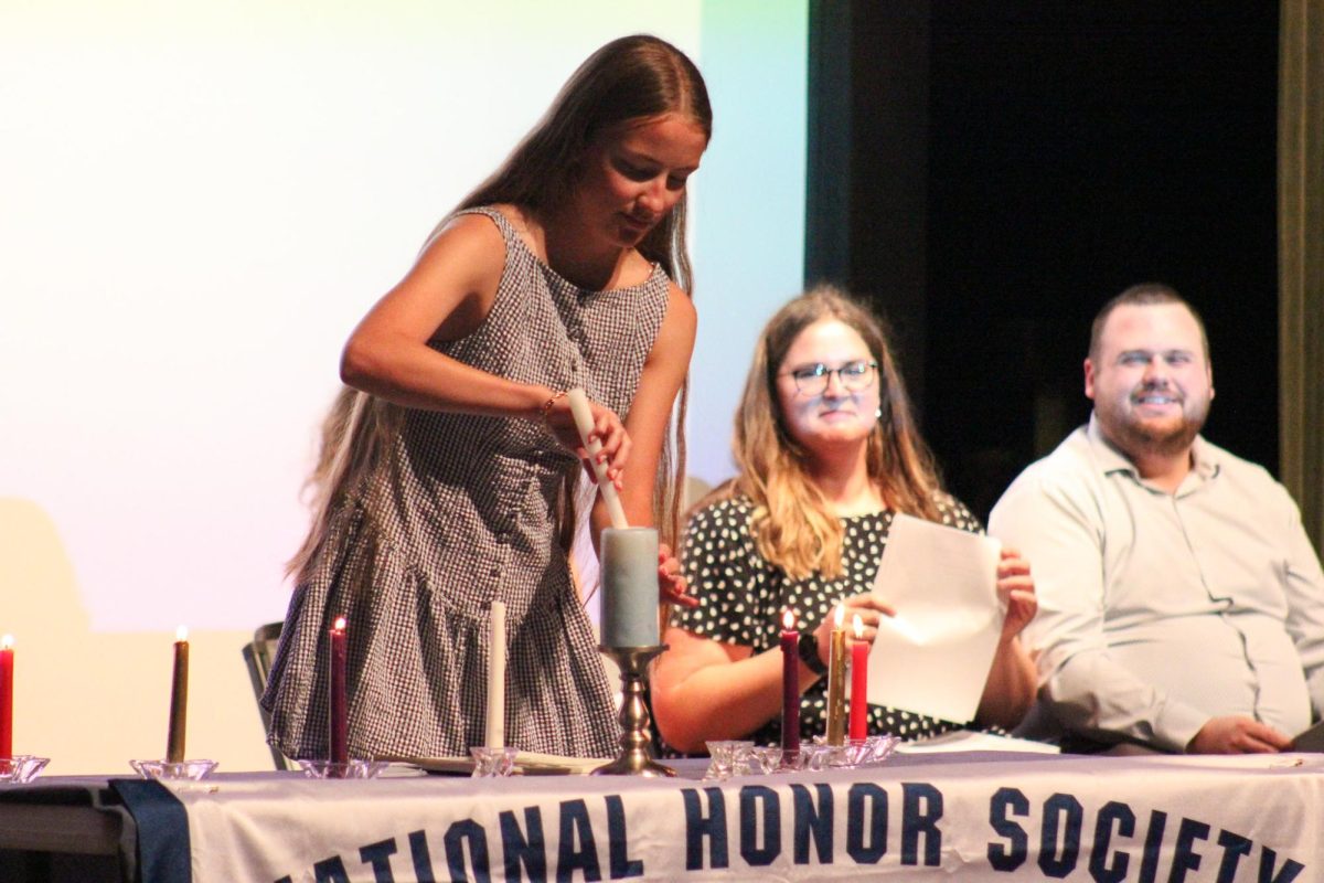 Senior Ellie Beran lights a candle.