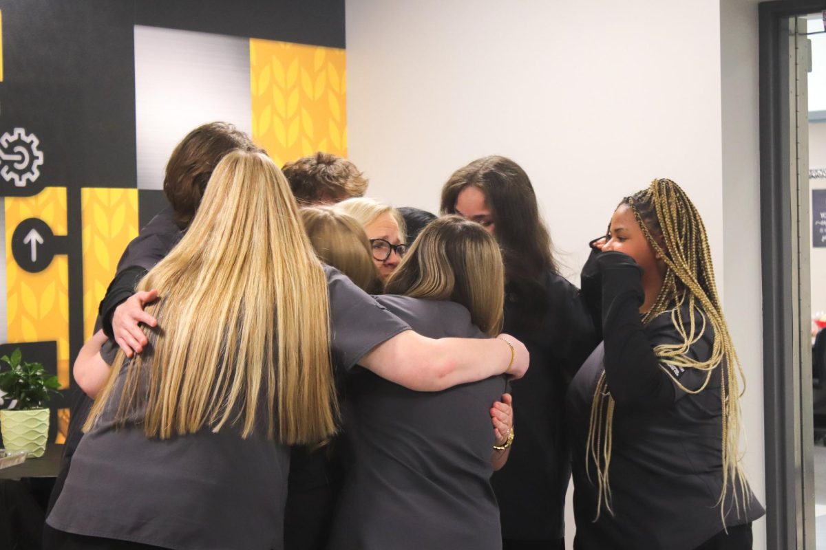 CNA group gives an emotional hug after officially being pinned.