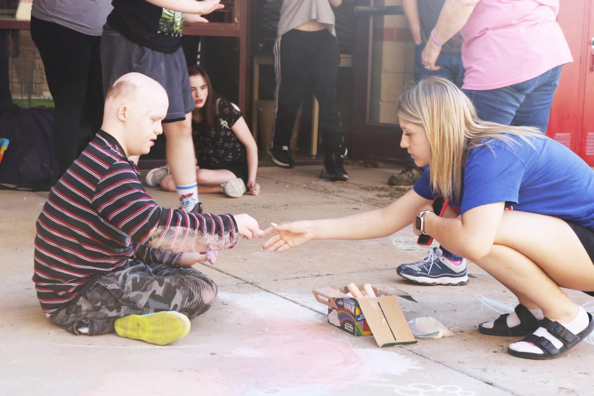 Students switch chalk colors. 
