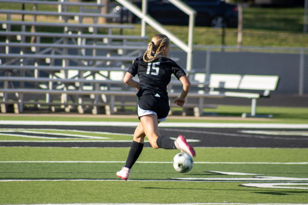 Player runs to get the ball. 