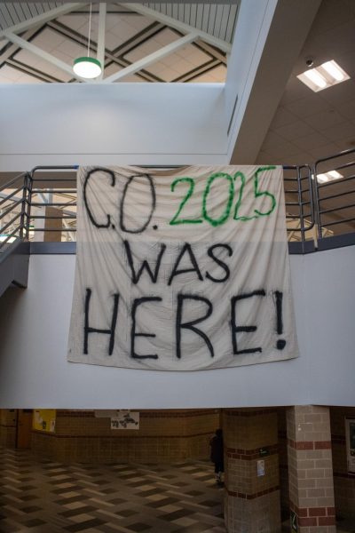 Seniors create a banner and hang it over the main stairs